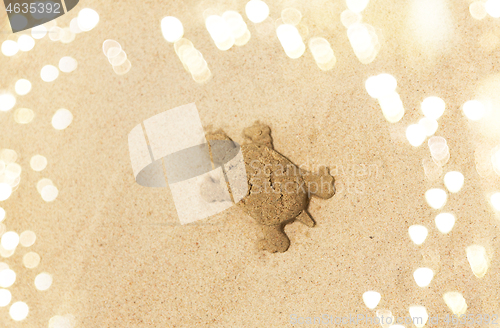Image of sand shape made by turtle mold on summer beach