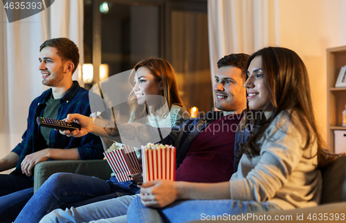 Image of friends with popcorn watching tv at home