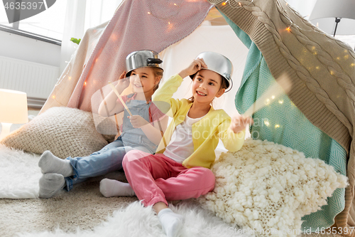 Image of girls with pots playing in kids tent at home