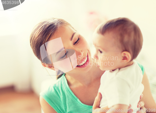 Image of happy young mother with little baby at home