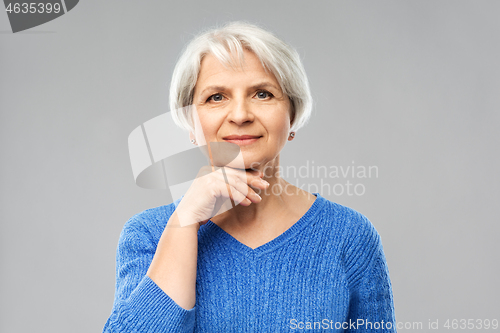 Image of portrait of lovely senior woman in blue sweater