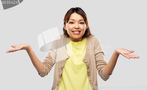 Image of clueless asian woman shrugging