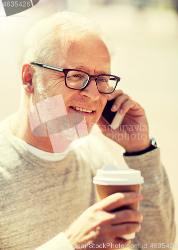 Image of happy senior man calling on smartphone in city