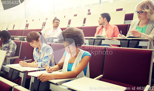 Image of group of students with notebooks at lecture hall