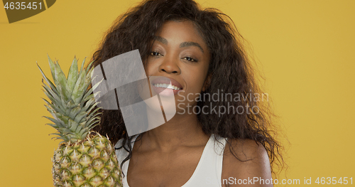 Image of Positive African American woman with pineapple