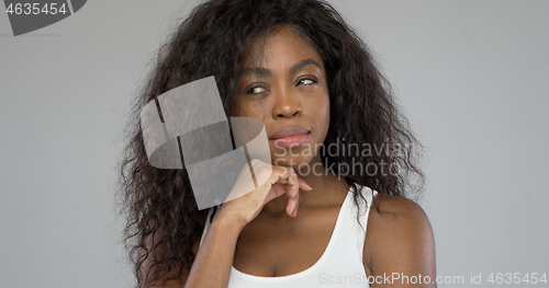 Image of Thoughtful ethnic female looking away