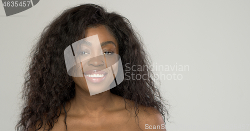 Image of Cheerful black woman looking at camera