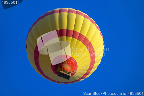 Image of Yellow hot air baloon flying in sky