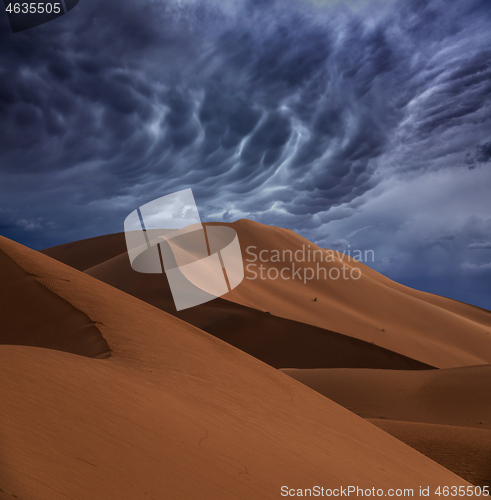 Image of sand dunes and storm clouds in desert