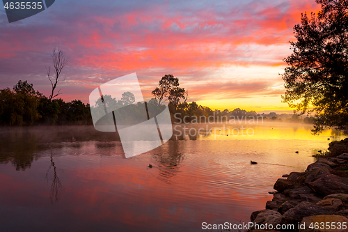 Image of Beautiful sunrise over the billabong with a light ground fog