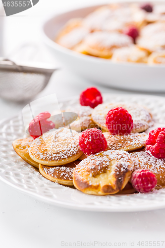 Image of Poffertjes - small Dutch pancakes with fresh raspberries 