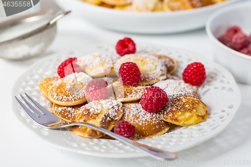 Image of Poffertjes - small Dutch pancakes with fresh raspberries 