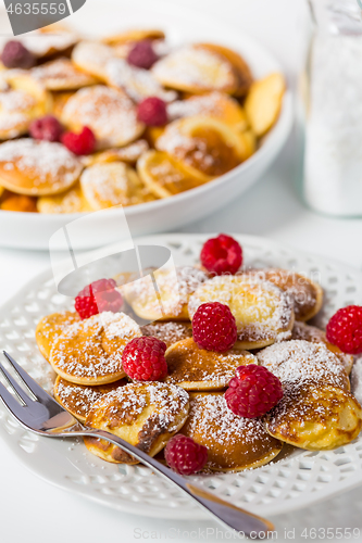 Image of Poffertjes - small Dutch pancakes with fresh raspberries 