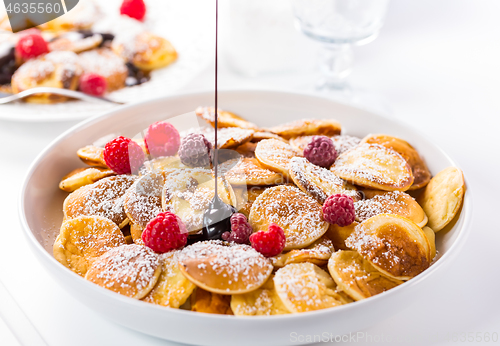 Image of Poffertjes - small Dutch pancakes with fresh raspberries 