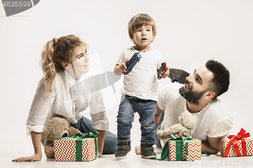 Image of happy family with kid together and smiling at camera isolated on white