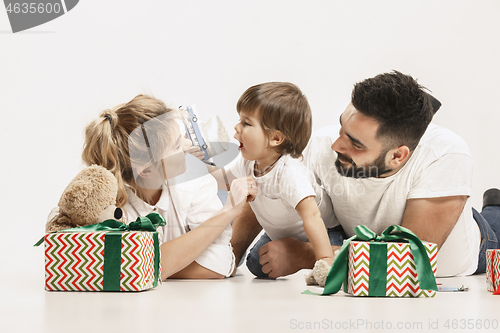 Image of happy family with kid together and smiling at camera isolated on white