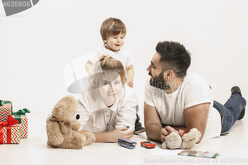 Image of happy family with kid together and smiling at camera isolated on white