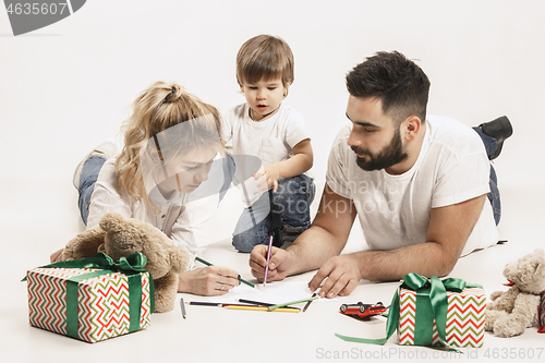 Image of happy family with kid together and smiling at camera isolated on white