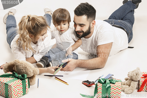 Image of happy family with kid together and smiling at camera isolated on white
