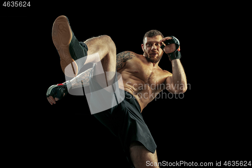 Image of professional boxer boxing isolated on black studio background