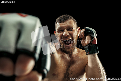 Image of professional boxer boxing isolated on black studio background