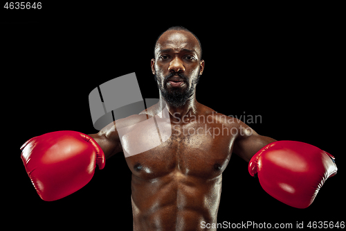 Image of Hand of boxer over black background. Strength, attack and motion concept