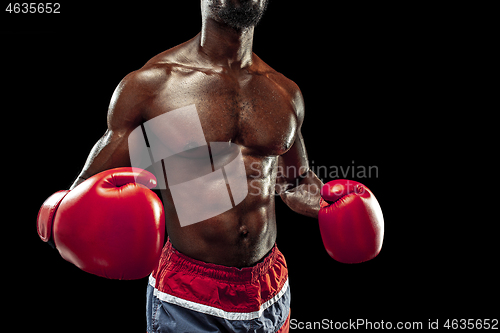 Image of Hand of boxer over black background. Strength, attack and motion concept