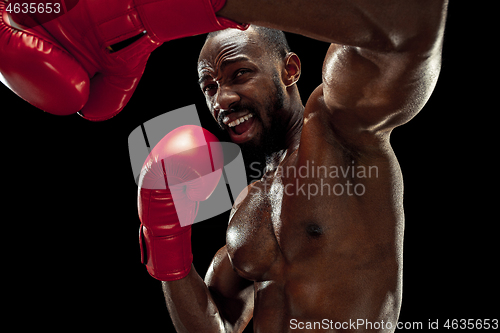 Image of Hand of boxer over black background. Strength, attack and motion concept