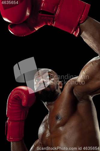 Image of Hand of boxer over black background. Strength, attack and motion concept