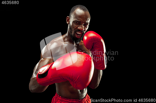 Image of Hand of boxer over black background. Strength, attack and motion concept