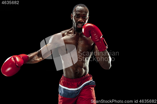 Image of Hand of boxer over black background. Strength, attack and motion concept