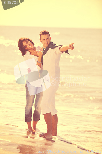 Image of happy young couple have fun at beautiful beach