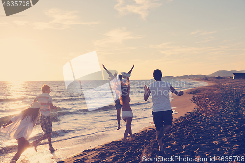 Image of people group running on the beach