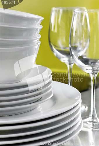 Image of Stack of Commercial White Plates Bowls and Wine Glasses