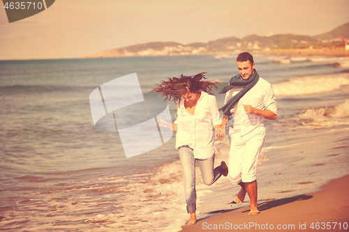 Image of happy young couple have fun at beautiful beach