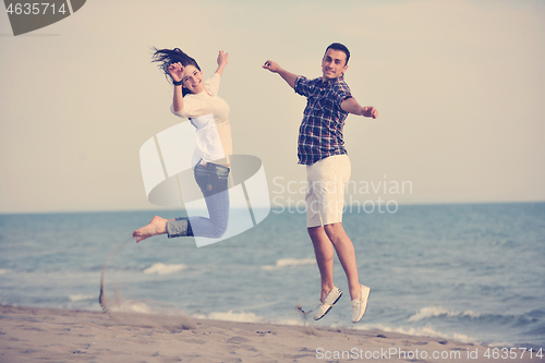 Image of happy young couple have fun on beach