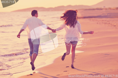Image of young couple  on beach have fun
