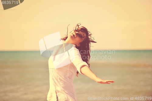 Image of happy young woman on beach