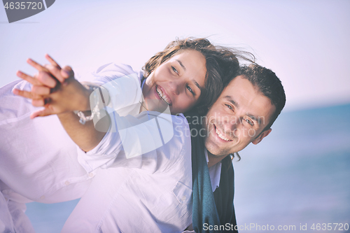 Image of happy young couple have fun at beautiful beach