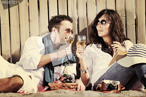 Image of young couple enjoying  picnic on the beach