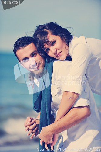 Image of happy young couple have fun at beautiful beach