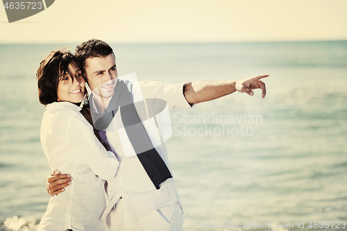 Image of happy young couple have fun at beautiful beach