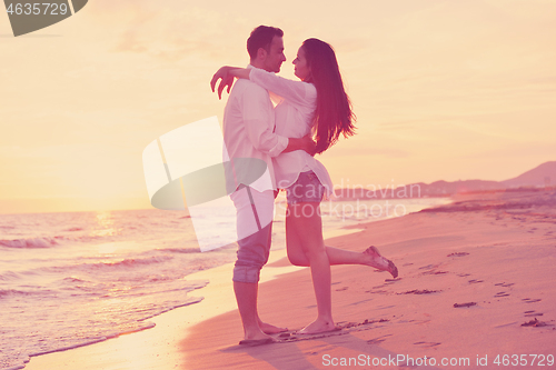 Image of young couple  on beach have fun