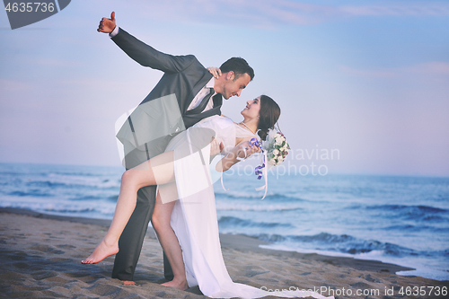 Image of romantic beach wedding at sunset