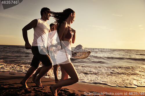 Image of people group running on the beach