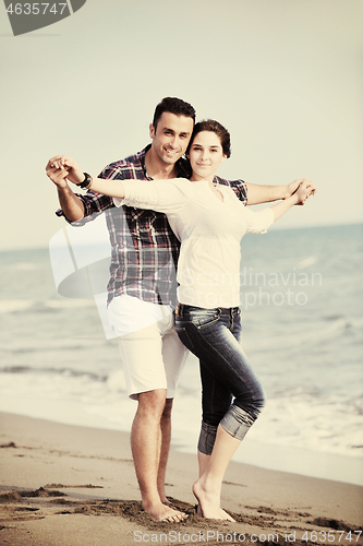 Image of happy young couple have fun on beach