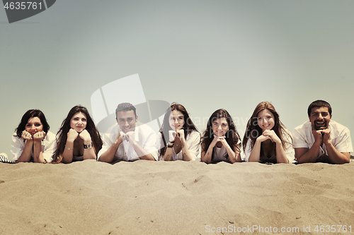 Image of Group of happy young people in have fun at beach