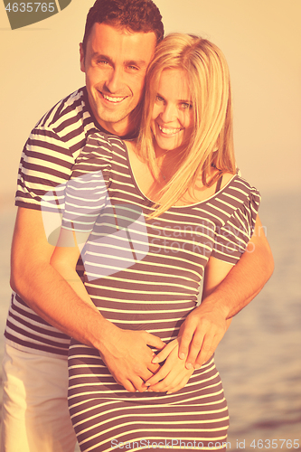 Image of happy young couple have romantic time on beach