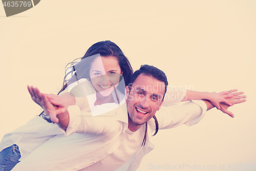 Image of young couple  on beach have fun