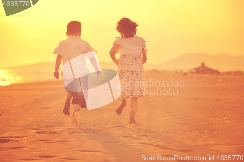 Image of happy young family have fun on beach at sunset